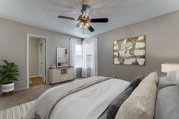 Bedroom with ceiling fan and neutral decor